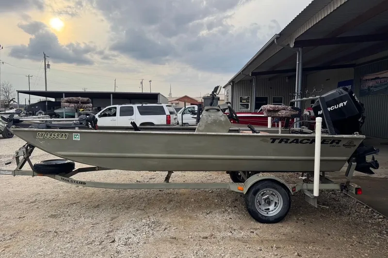 Slide: The Image of 2007 Tracker Grizzly 1754 CC All-Welded boat on trailer, parked outdoors. - 7