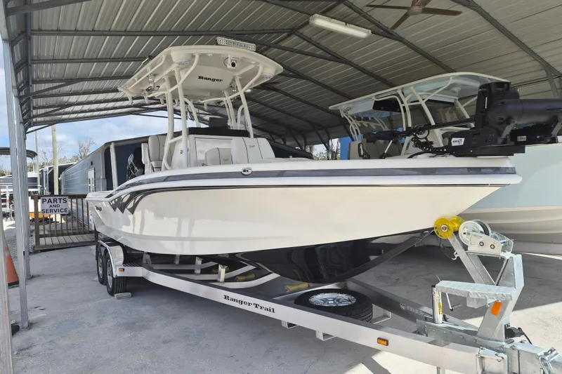 The Image of 2025 Ranger 2600 Bay boat on trailer in covered storage area. - 1