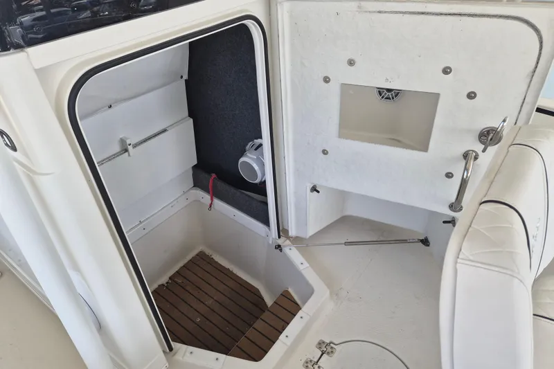 Slide: The Image of 2025 Ranger 2600 Bay boat interior with storage compartment and seating area. - 17