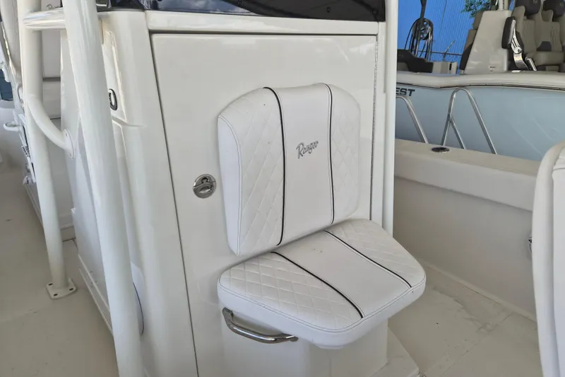 Slide: The Image of 2025 Ranger 2600 Bay boat interior with white cushioned seating and sleek design. - 18