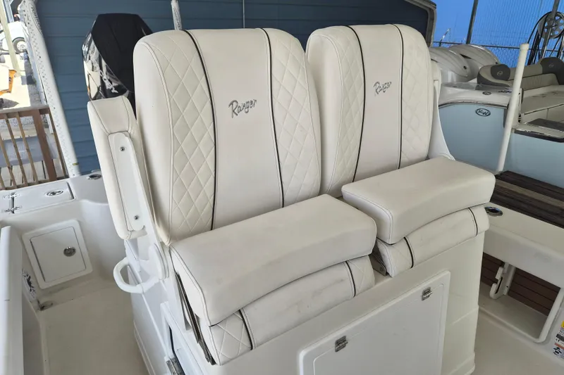 Slide: The Image of 2025 Ranger 2600 Bay boat with luxurious white leather seating. - 20