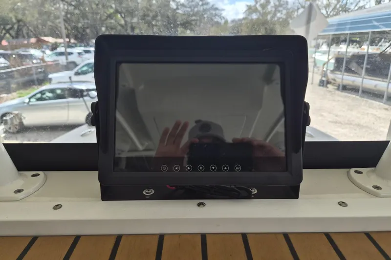 Slide: The Image of Dashboard screen on 2025 Ranger 2600 Bay boat, reflecting surroundings. - 24