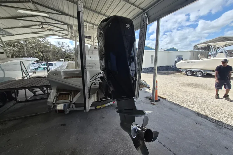 Slide: The Image of 2025 Ranger 2600 Bay boat with outboard motor in covered storage area. - 3