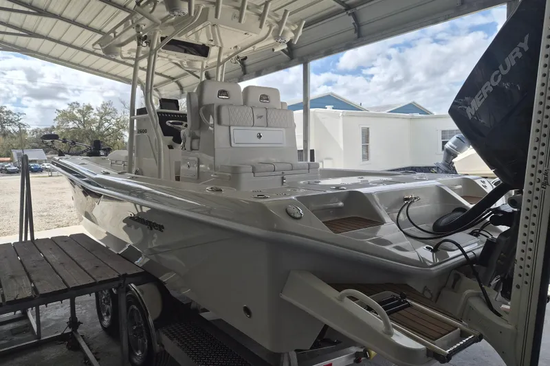 Slide: The Image of 2025 Ranger 2600 Bay boat under a metal canopy, featuring a Mercury engine. - 4