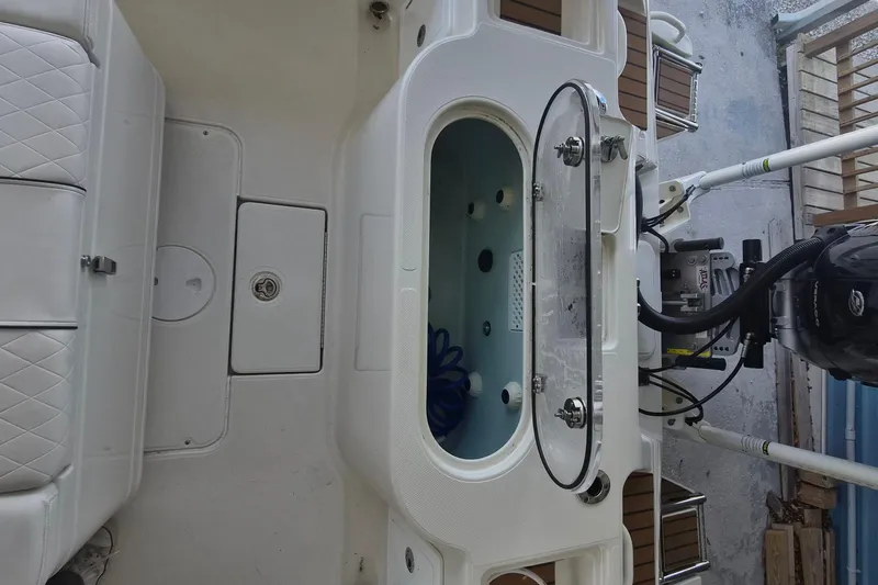 Slide: The Image of 2025 Ranger 2600 Bay boat interior with seating and engine details. - 7