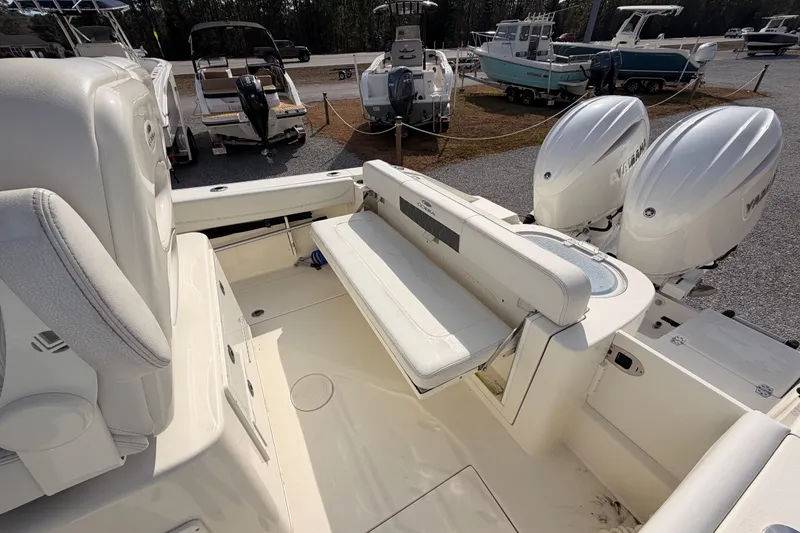 Slide: The Image of 2024 Cobia 262 Center Console boat with dual engines and spacious seating area. - 11