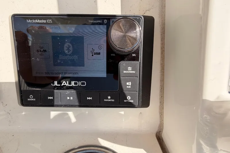 Slide: The Image of JL Audio MediaMaster 105 on 2024 Cobia 262 Center Console boat, featuring Bluetooth and USB options. - 18