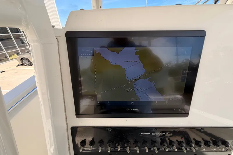 Slide: The Image of 2024 Cobia 262 Center Console with Garmin navigation display showing map. - 19