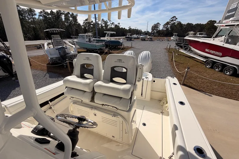 Slide: The Image of 2024 Cobia 262 Center Console boat interior with dual seats and steering wheel. - 24