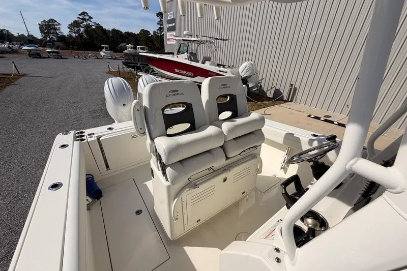 Slide: The Image of 2024 Cobia 262 Center Console boat interior with dual seats and steering wheel. - 25