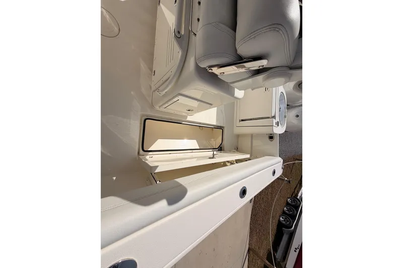 Slide: The Image of 2024 Cobia 262 Center Console boat interior with seating and storage compartments. - 26