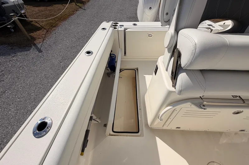 Slide: The Image of 2024 Cobia 262 Center Console boat interior with storage compartment and seating. - 28