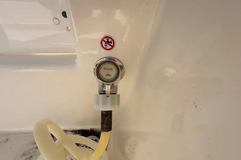 Slide: The Image of 2024 Cobia 262 Center Console raw water washdown outlet with hose attachment. - 29