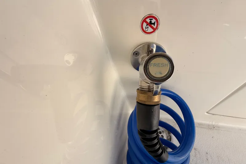 Slide: The Image of Freshwater hose connection on 2024 Cobia 262 Center Console boat. - 30