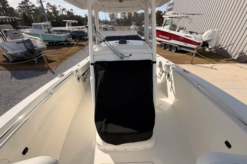 Slide: The Image of 2024 Cobia 262 Center Console boat, interior view, parked in a marina. - 35