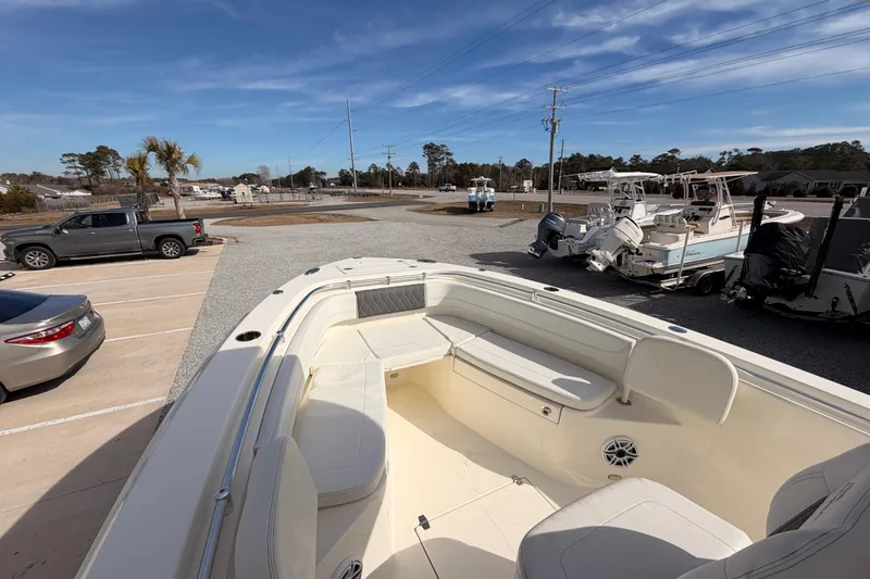 Slide: The Image of 2024 Cobia 262 Center Console boat in a parking lot with clear blue sky. - 8
