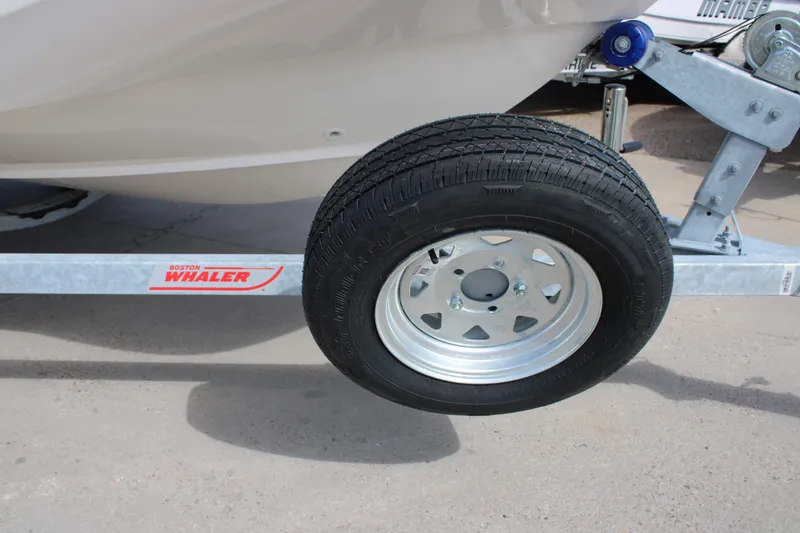 Slide: The Image of 2026 Boston Whaler 150 Montauk trailer wheel and frame close-up. - 10