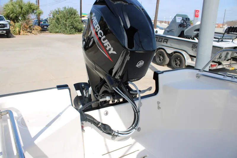 Slide: The Image of 2026 Boston Whaler 150 Montauk with Mercury outboard motor in a marina setting. - 11