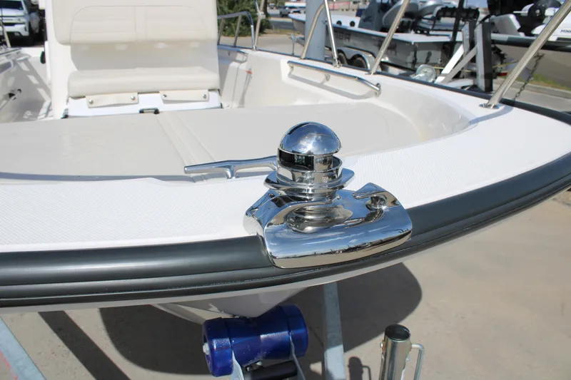 Slide: The Image of 2026 Boston Whaler 150 Montauk boat with chrome details and seating area. - 14