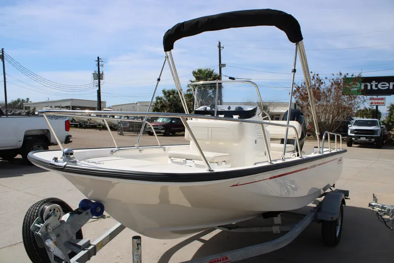 Slide: The Image of 2026 Boston Whaler 150 Montauk boat on trailer, outdoor dealership setting. - 23