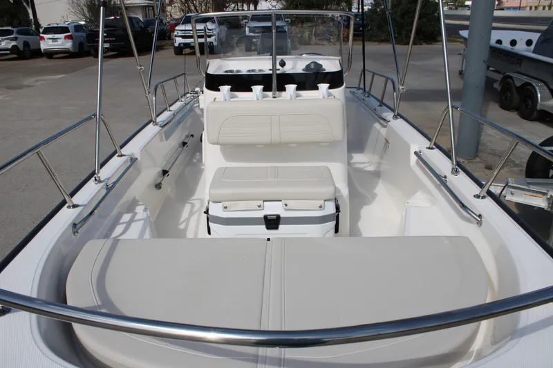 Slide: The Image of 2026 Boston Whaler 150 Montauk boat interior with seating and console view. - 4