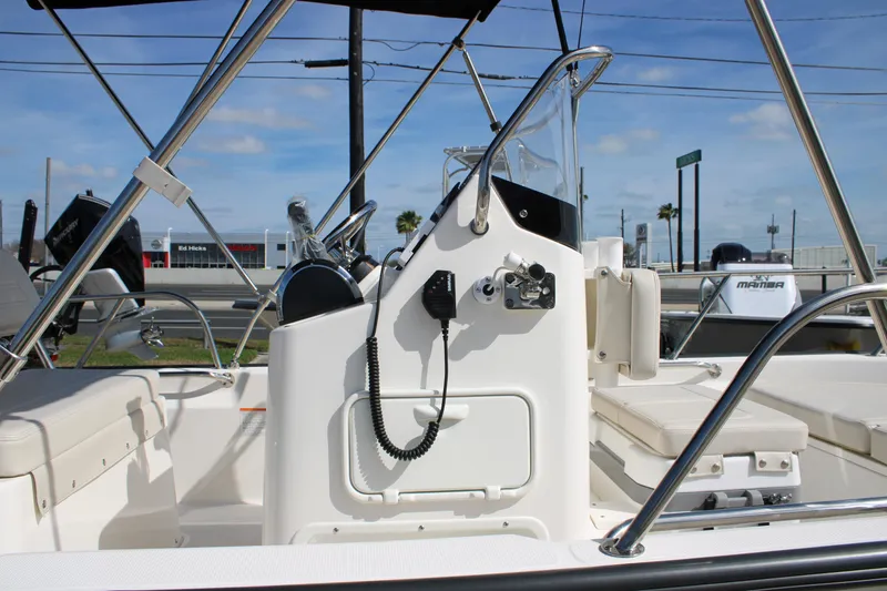 Slide: The Image of 2026 Boston Whaler 150 Montauk boat interior with steering console and seating. - 7