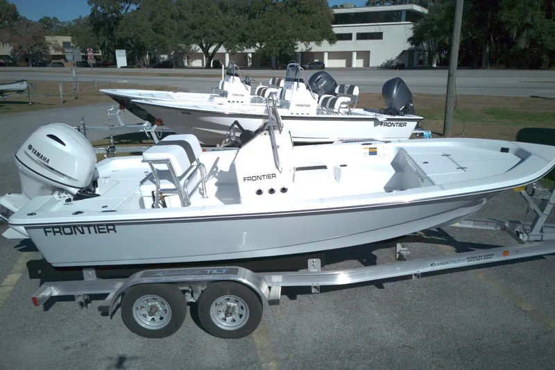 The Image of 2026 Frontier 180 boat on trailer, featuring Yamaha engine, parked outdoors. - 1