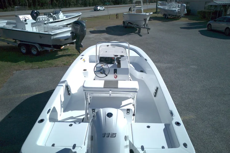Slide: The Image of 2026 Frontier 180 boat with Yamaha engine, parked outdoors on a sunny day. - 10