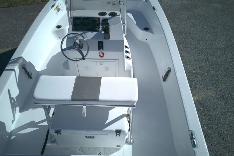 Slide: The Image of 2026 Frontier 180 boat interior with steering wheel and seating, viewed from above. - 11