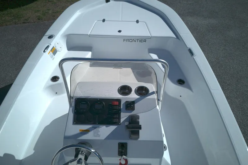 Slide: The Image of 2026 Frontier 180 boat interior with steering console and controls, viewed from above. - 12