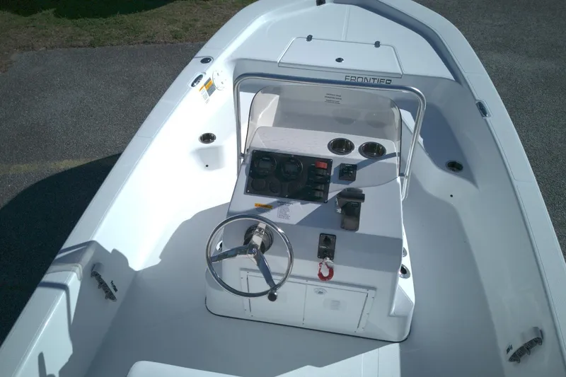 Slide: The Image of 2026 Frontier 180 boat interior with steering wheel and control panel. - 13