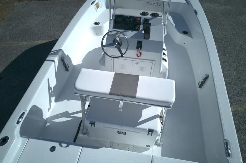 Slide: The Image of 2026 Frontier 180 boat interior with steering console and seating, showcasing modern design. - 14