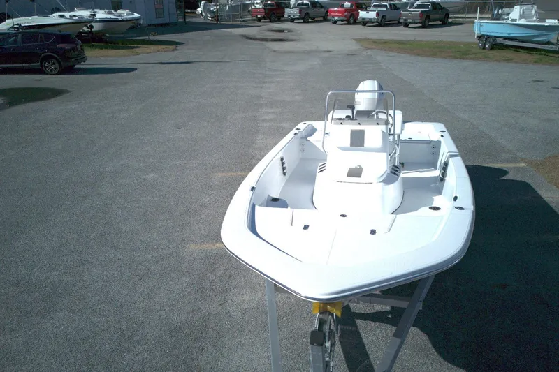 Slide: The Image of 2026 Frontier 180 boat on trailer in parking lot, surrounded by vehicles and other boats. - 15