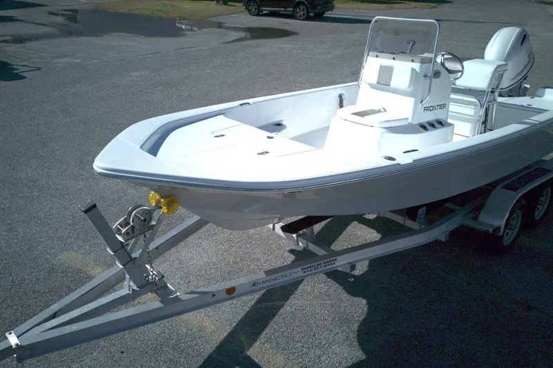 Slide: The Image of 2026 Frontier 180 boat on trailer, parked in a lot, ready for transport. - 4