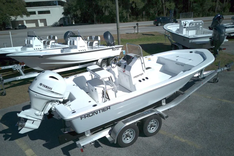 Slide: The Image of 2026 Frontier 180 boat with Yamaha engine on trailer, parked outdoors. - 9