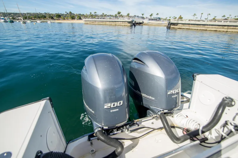 Slide: The Image of 1997 Boston Whaler 24 Outrage with twin Yamaha 200 engines on calm water. - 14