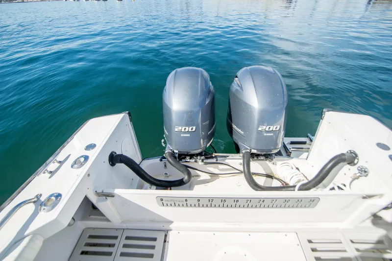 Slide: The Image of 1997 Boston Whaler 24 Outrage with dual Yamaha 200 engines on calm water. - 15