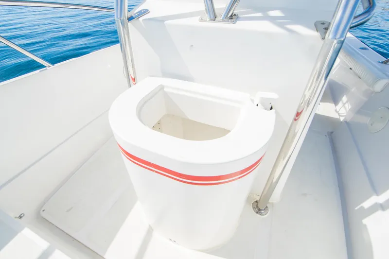 Slide: The Image of 1997 Boston Whaler 24 Outrage boat interior with white seating and red stripe. - 16