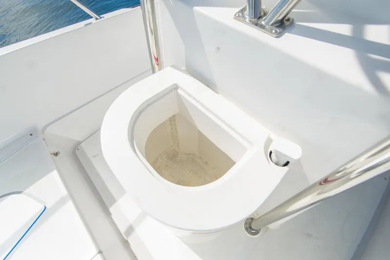 Slide: The Image of Boston Whaler 24 Outrage 1997 boat toilet, white interior, stainless steel railing. - 17