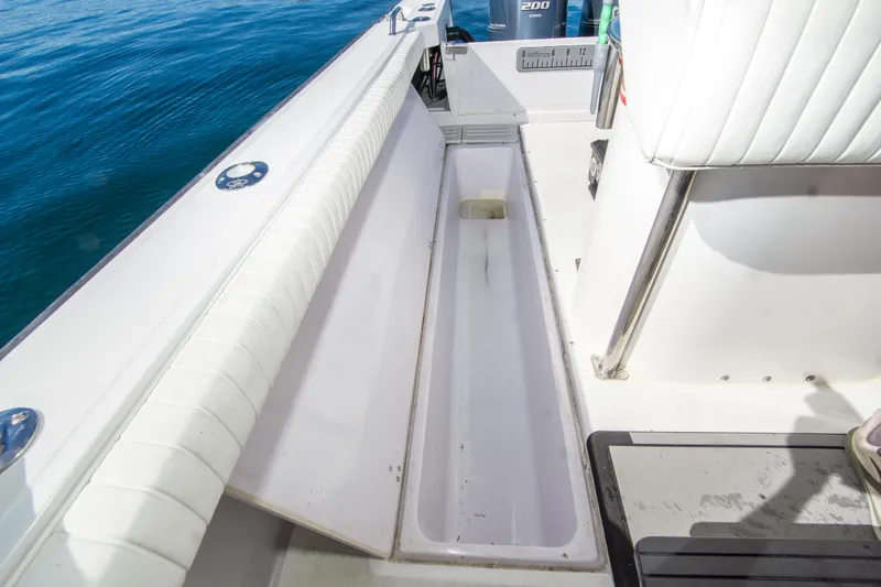 Slide: The Image of 1997 Boston Whaler 24 Outrage boat interior with open storage compartment. - 18