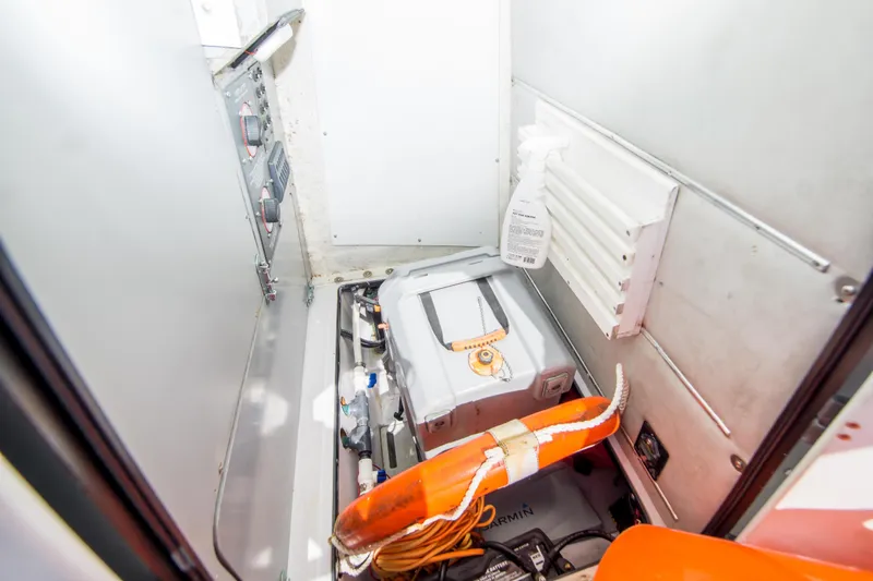 Slide: The Image of Interior of a 1997 Boston Whaler 24 Outrage boat, featuring equipment and storage. - 20