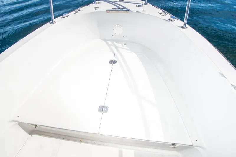 Slide: The Image of 1997 Boston Whaler 24 Outrage boat deck, featuring clean white surface and ocean backdrop. - 7