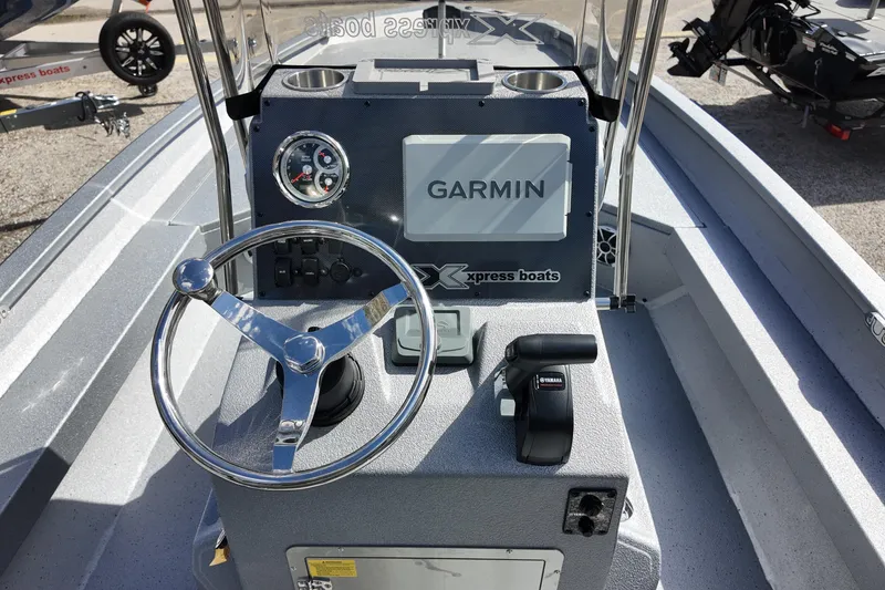 Slide: The Image of 2026 Xpress H22B Bay boat dashboard with Garmin navigation system and Yamaha controls. - 5