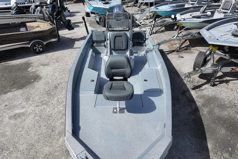 Slide: The Image of 2026 Xpress H22B Bay boat with sleek design, parked among other boats. - 7