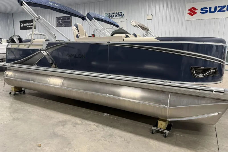 Slide: The Image of 2026 Avalon LSZ Elite 21' pontoon boat in showroom, featuring sleek design and modern amenities. - 3