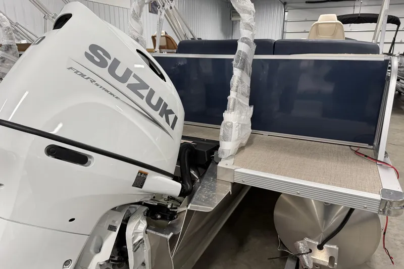 Slide: The Image of 2026 Avalon LSZ Elite 21' with Suzuki outboard motor in a showroom. - 6