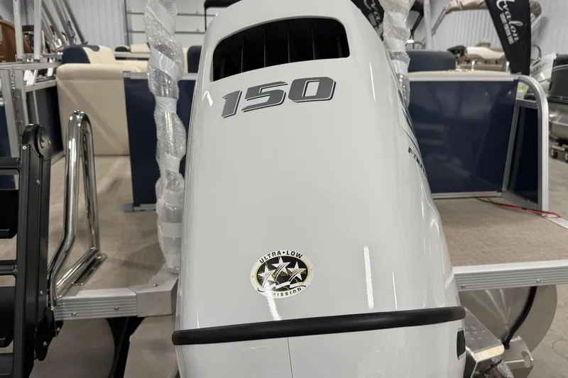 Slide: The Image of 2026 Avalon LSZ Elite 21' boat with 150 horsepower engine, displayed indoors. - 7