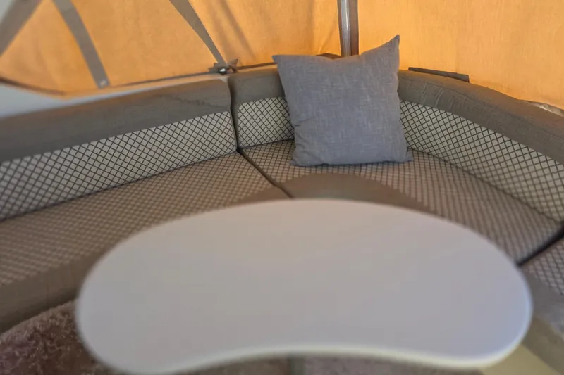 Slide: The Image of Interior seating area of 2000 McKinna 48 Pilothouse with cushioned bench and table. - 12