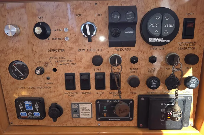 Slide: The Image of Control panel of a 2000 McKinna 48 Pilothouse with various switches and indicators. - 18
