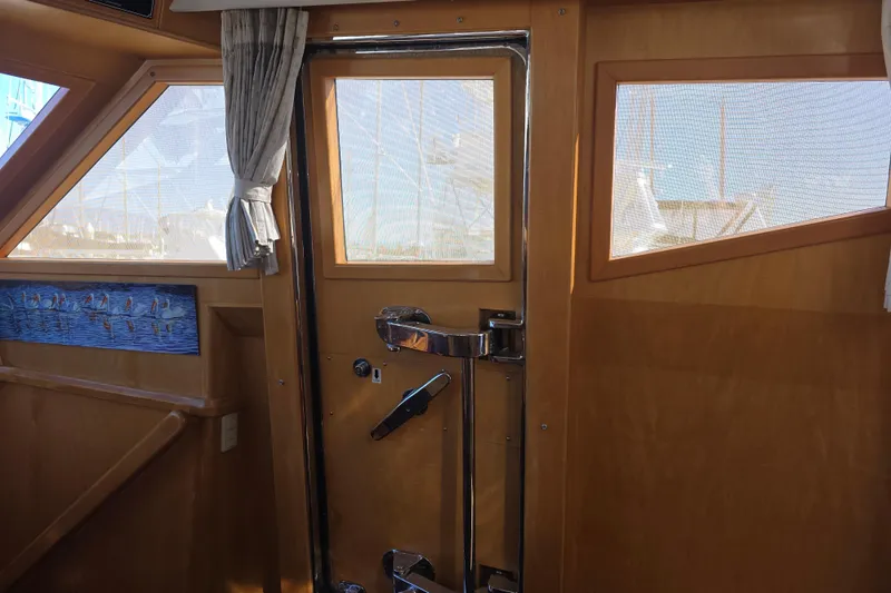 Slide: The Image of Interior of 2000 McKinna 48 Pilothouse with wooden door and windows. - 19